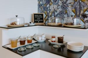 a shelf with different kinds of food on it at Hôtel Le Windsor Biarritz in Biarritz