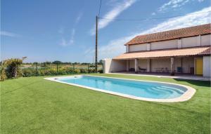 a swimming pool in a yard next to a house at Le Jardin in Le Sambuc