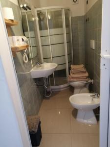 a bathroom with a sink and a toilet at B&B La Riserva Nuova in Aprilia