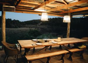 a wooden table on a patio with a view at Burlington Bush Cottages by The Oyster Collection in Salem +44 photos