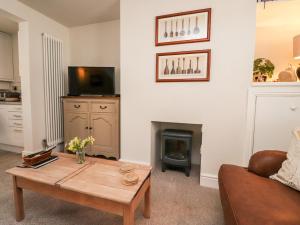a living room with a coffee table and a fireplace at Bay Cottage No 5 in Morecambe