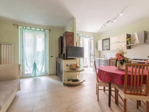 a living room with a table and a kitchen at Apartment Cristina by Interhome in Riva Ligure