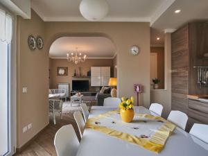 a dining room and living room with a white table and chairs at Holiday Home Anna by Interhome in Luino