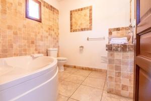 a bathroom with a tub, toilet, sink and bathtub at Osteria A Stalla Sischese & Spa in Sisco