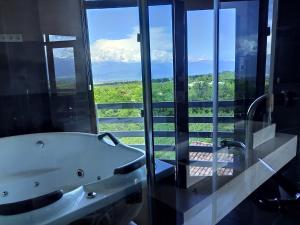 a bath tub in a bathroom with a view at Savaneti Eco Hotel in Tʼelavi