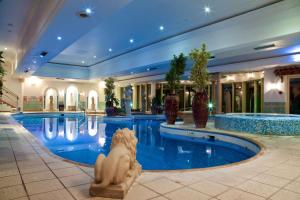 a swimming pool with a pool table and chairs at Derby Mickleover Hotel, BW Signature Collection in Derby