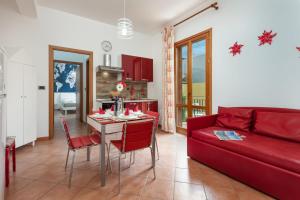 聖維托羅卡波的住宿－Residence I Tesori di San Vito，客厅配有红色的沙发和桌子
