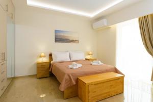 een slaapkamer met een bed met twee handdoeken erop bij Melia deluxe city view apartment in Agios Nikolaos