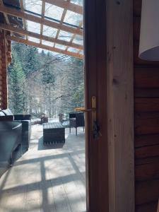 a door to a porch with a view of a patio at Voronins Retreat House in Lumshory