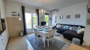 a living room with a table and a couch at Apartman Mare in Makarska