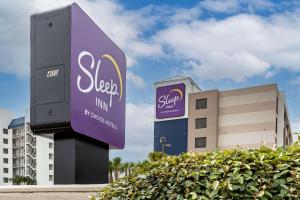a sign for a spa inn in front of a building at Sleep Inn Orange Beach in Orange Beach