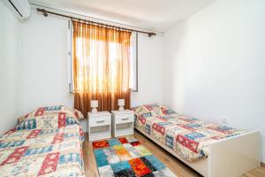 a bedroom with two beds and a window at Apartment Kos in Dubrovnik