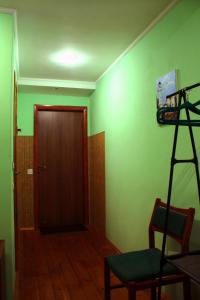 a room with a green wall with a ladder and a door at motel Pid Strihoyu in Kremenchuk