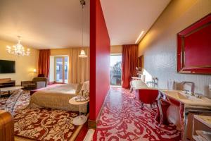 a hotel room with a bed and a bathroom at Harmony Park Hotel & SPA in Prienai