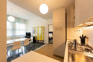a kitchen and dining room with a dining table at Por Santa Maria Apartment in Florence
