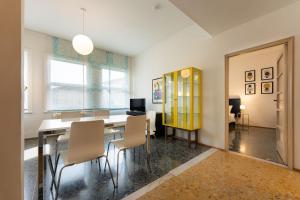 a dining room with a table and chairs at Por Santa Maria Apartment in Florence