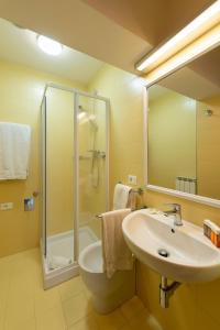 a bathroom with a sink and a shower at Por Santa Maria Apartment in Florence +24 photos