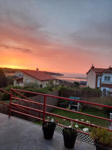 a sunset from the balcony of a house at Adosado con vistas al mar los GIRASOLES in Mogro