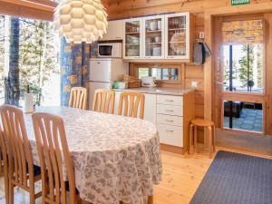 uma cozinha e sala de jantar com mesa e cadeiras em Holiday Home Villa rukaherttua by Interhome em Ruka