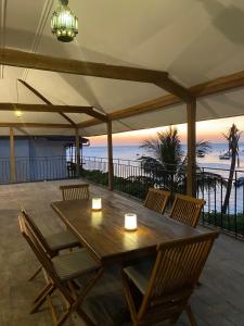 a wooden table and chairs with a view of the ocean at David Livingstone's Home in Zanzibar City