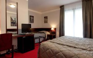 Postel nebo postele na pokoji v ubytování Hostellerie St Vincent