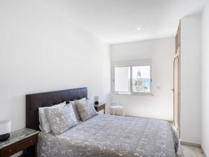 a white bedroom with a bed and a window at Apartment Casa Avó Lucy by Interhome in Portimão