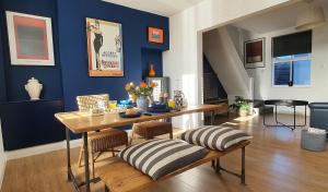 a dining room with a wooden table and blue walls at 37 Trinity Lane in Beverley