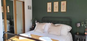 a bedroom with a bed with white sheets and pillows at 37 Trinity Lane in Beverley