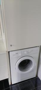a white washing machine sitting in a kitchen at Ευχάριστη βίλα στη Χαλκίδα στην περιοχή ''Αλυκές'' in Chalkida