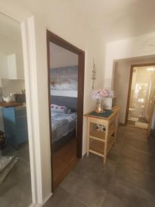 a bedroom with a mirror and a bed and a table at LEA in Bakarac