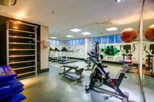 a gym with bikes and weights in a room at Quality Rio de Janeiro - Barra da Tijuca in Rio de Janeiro