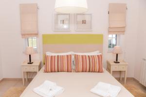 a bedroom with a large bed with two night stands at Casa Querida in Óbidos +38 photos