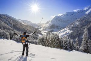 a man standing on top of a snow covered mountain at Hausbergerhof Gästehaus Ainberger in Brixlegg