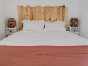 a bedroom with a large white bed with two night stands at ** Nouveau ** Le Jardin De La Plage - Appartement avec extérieur in Saint-Jorioz