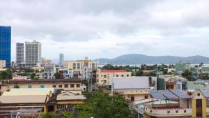 a city with buildings and mountains in the background at Học Hương Hotel Quy Nhơn in Quy Nhon