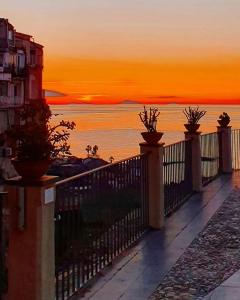 a view of the ocean from a balcony at sunset at Dreams Tropea Mare "Private Parking" in Tropea