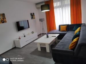 a living room with a couch and a coffee table at Markaz Apartman Bihać 2 in Bihać