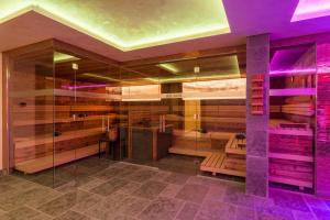 a room with a shower with purple lighting at FOR MOMENTS Apartments & Spa in Roßhaupten