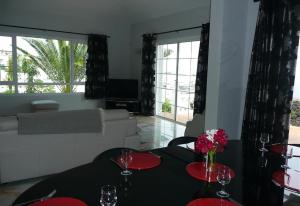 a living room with two tables with wine glasses at Villa Loretta in Puerto del Carmen