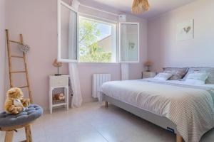 a bedroom with a bed and a ladder and a window at Les Vergers in Gonfaron +6 photos