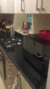 a kitchen with a stove and a black counter top at j16 in Hurghada