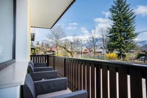 a balcony with chairs and a view of the mountains at Apartma Lida 1 in Bled