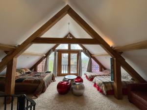 a attic room with two beds and a window at Ty Nofio, Coity Bach in Brecon