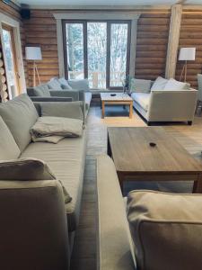 a living room with couches and a table at Voronins Retreat House in Lumshory