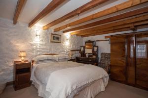 a bedroom with a large bed and a desk at Vivers Mill in Pickering