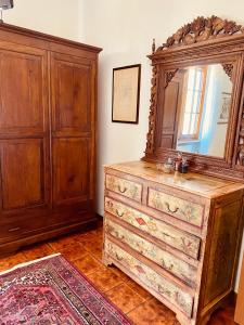 a dresser with a mirror on top of it at villa porta a colle in Castiglione della Pescaia