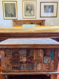 a large wooden table with a bed on top at villa porta a colle in Castiglione della Pescaia