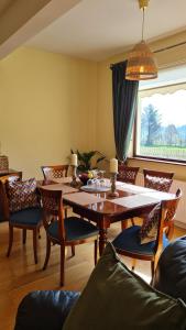 a dining room with a wooden table and chairs at Yellow Heights Country House in Tinahely