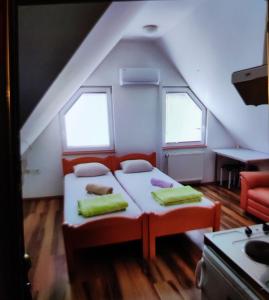 a bedroom with two beds in a attic at Apartments Luxe Self Check in in Zagreb