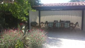 a patio with a table and chairs under a pavilion at Casa Daniela in San Felice Circeo